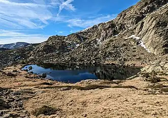 A body of water surrounded by mountains.