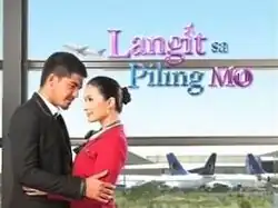 An image of Heart Evangelista and Mark Herras looking at each other. An airplane flying and airplanes on land are seen in the background. The series title is displayed on the upper side of the image.