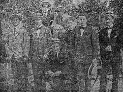 with colleagues (squatting), 1910s