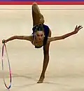 Rotating the hoop around its axis on the floor during a balance (Liliana Lewińska)
