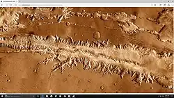Wide view of part of Ius Chasma with the Louros Valles along its southern margin.