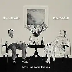 A '50s-style grayscale painting of a man and a woman sitting in chairs next to a roundtable with flowers and a vase and two bottles. The man is dressed in shirt and pants, and holds a glass. The woman wears a mid-calf length flowered dress and high heel shoes. Original painting by Martin Mull.