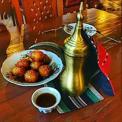 Image 3Luqaimat (lugaimat in Emirati dialect), a traditional Emirati dessert, served with Arabic coffee. (from Emirati cuisine)