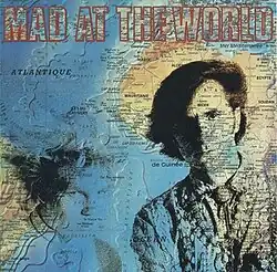 two long-haired, well-coiffed teens superimposed on a map of Africa, the South Atlantic Ocean, and part of South America with the album's title: Mad at the World, in outlined lettering across the top