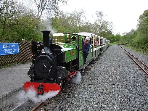 Image 37Ruislip Lido Railway's 12-inch (300 mm) gauge locomotive "Mad Bess" hauling a passenger train.