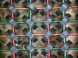 50x photograph of magnetic core random access memory from a 4 KiB memory plane.