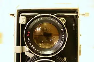 Top lens of 105 mm unit with lens retainer clip above