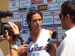 A photo of Marco Biagianti being questioned by sports reporters at the Massannunziata Sports Centre.