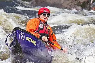 A whitewater canoeist paddling a Roxalex canoe.