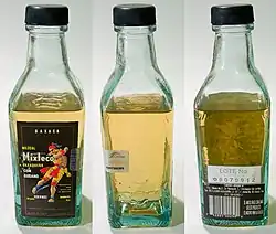 Image 1Various views of a bottle of mezcal. The "worm", which is actually the larval form of the moth Hypopta agavis that lives on the agave plant, can be seen in the middle image, at the bottom of the bottle. (from List of alcoholic drinks)