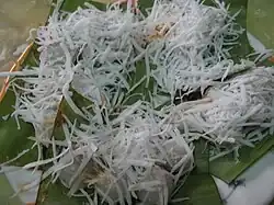 Mont lone yei baw – glutinous rice balls filled with jaggery, covered with shredded coconut – a New Year treat