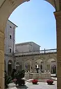 Cloister with fountain behind the benefactors' cloister