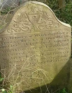 An engraved sandstone gravestone.