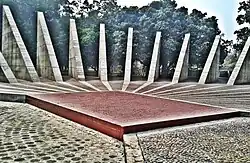 The Mujibnagar monument has 23 pillars, some of which are shown here, representing the 23 years of Pakistani rule over East Bengal before it became independent as Bangladesh. The red brick square marks the spot where the Mujibnagar government ministers took their oaths.[1]