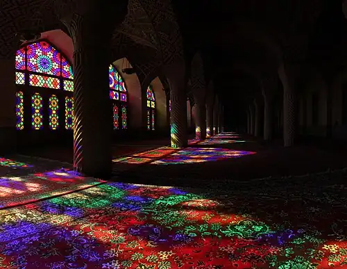 Extensive stained glasses of Nasir-ol-Molk Mosque in Shiraz, Iran, and the light passing through them