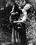 Photograph of Nell Shipman and a bear