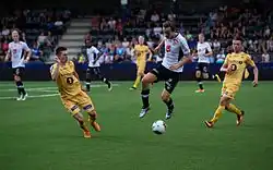 Ole Amund Sveen scoring a goal against Bodø-Glimt on July 24, 2016. He is mid-air, surrounded on both sides by Bodø-Glimt players.