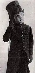 Boy dressed as a funeral mute