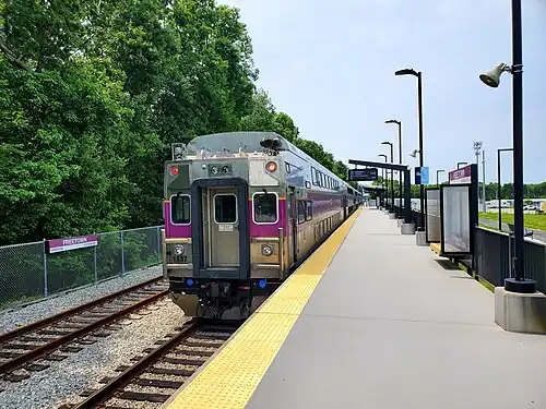 A passenger train at high-level railway platform