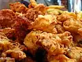 Pakoras being deep-fried in gram flour batter