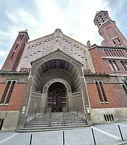 The portal, below a statue of Saint Christopher and the Christ child.
