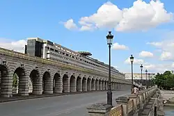 The Metro line 6 viaduct over pont de Bercy and the Colbert building in perspective from the opposite bank.