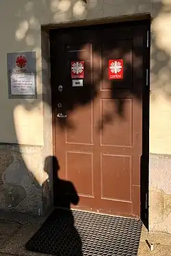 Side door of the Church of St. Anthony of Padua (Kaunas) [lt] with signs of the local parish Caritas.