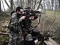 Three airsoft team members during a field game