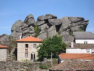 Granite outcrop among village houses, Penela da Beira