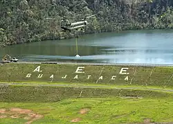 A Chinook lifting a big sandbag to reinforce the spillway, October 9