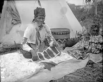 Ashatcheway, a Cree Medicine Man smoking an effigy pipe, Waterhen River Area, Northern Saskatchewan