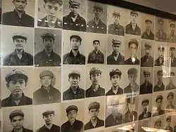 Black and white photographs of child soldiers in a display case.