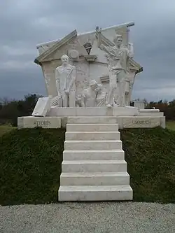 White stone memorial, with steps and people escaping