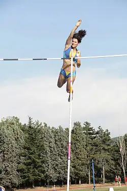 Image 19Anna Giordano Bruno releases the pole after clearing the bar in pole vault (from Track and field)