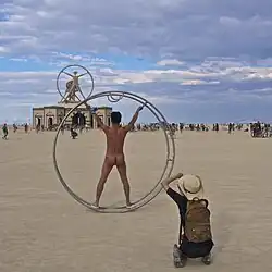 Image 29Naked participant at Burning Man 2016 posing as Leonardo da Vinci's Vitruvian Man (from Naturism)