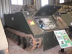 Colour photo of a green tracked military vehicle