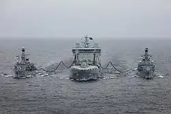 RFA Tiderace conducting a dual RAS with two Royal Navy frigates