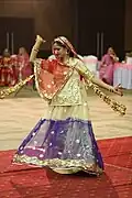 Woman with a ghoonghat performing a Ghumar dance.