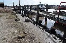 Site of old bridge. Rails can be seen sinking in the mud