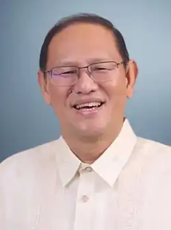 Teodoro in 2025 wearing a white barong tagalog and thin square glasses