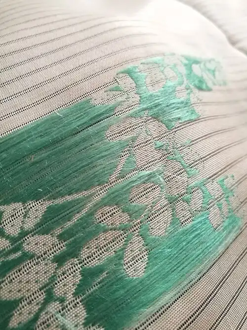 Reverse view of flat silk embroidery on ro weave
