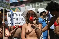 A demonstrator protesting for equal rights for women, wearing a pastie in the form of a nipple (2011)
