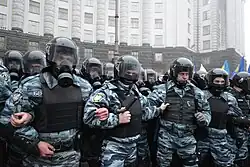 Defensive line of "Berkut" unitmen in riot gear by the Cabinet of Ministers building in Kyiv during 2013 Euromaidan protests.