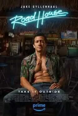 Jake Gylenhaal's Elwood Dalton sits with bruises, cuts, and an unbuttoned shirt in the middle of a roadhouse.