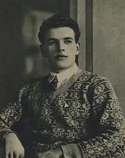 Rudolf Bukert from the torso up wearing a sweater. Image is in black and white.