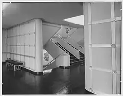 An onboard stairway, with an aluminum sculpture of the Great Seal of the United States on each landing.: 93