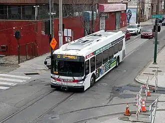 A diesel bus on an urban street