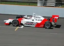 Red-and-white racing car on a track