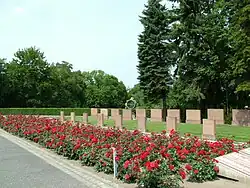 Graves of soldiers at the Seelow Heights. In the background, an APM-90 searchlight used during the attack on the Seelow Heights