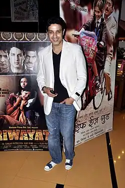 A man in white blazers at a film premiere